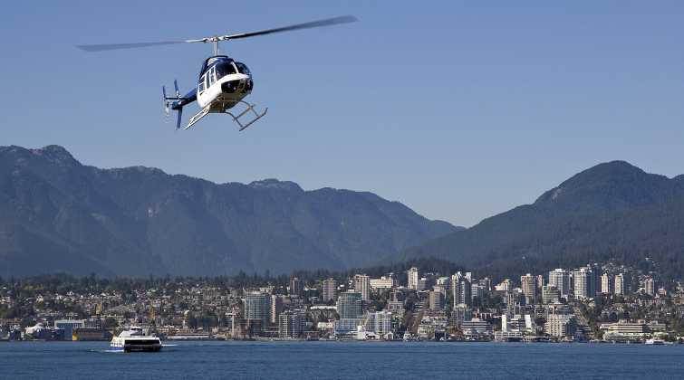 Heli jet helicopter on a charter flight in Burrard Inlet near downtown Vancouver, BC, Canada. Kelown