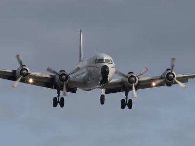 Larger cargo airplane coming in for landing with cargo load.